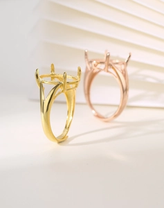 Detail of four-prong silver ring settings in gold and rose gold with split shank design