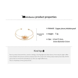 Detailed view of gold double-layer bangle with zircon flower and pearl showing 5.6cm diameter