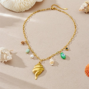 Detail of gold-plated ocean theme necklace with starfish, seashell and evil eye charms