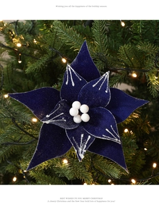 Close-up of dark blue velvet poinsettia with silver glitter edges and pearl center