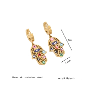 Detailed view of hollow Hamsa hand earrings in gold stainless steel with colorful eye detail