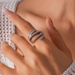 Detail of multi-layer crossover ring with sparkling round and baguette cubic zirconia stones