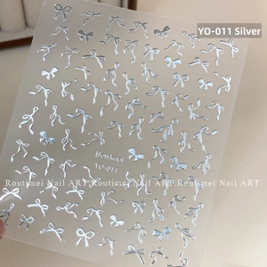 Detail of silver embossed 3D bowknot nail art stickers with metallic finish on sheet YO-011
