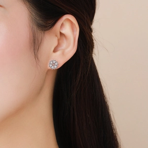 Elegant S925 silver flower stud earrings with clear zircon stones on a model's ear