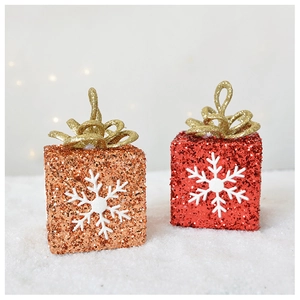 Detailed view of glittering red and copper Christmas box ornaments with white snowflakes