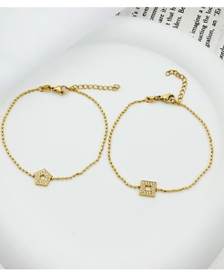 Close-up of gold-plated beaded bracelets with square and pentagon zircon pendants