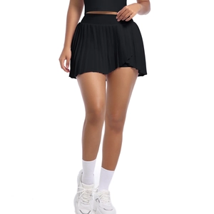 Close-up of black pleated sports skort with high-waist elastic band for tennis and golf