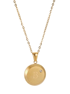 Detailed view of round gold pendant with letter B engraving and small inlaid crystal stone