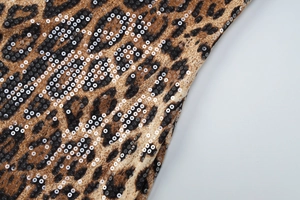 Detailed macro view of leopard print fabric with high-density shimmering sequins