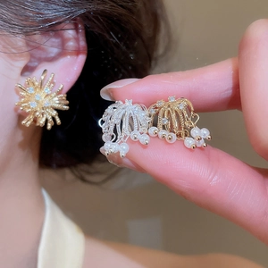 Close-up detail of 18k gold plated firework ear clips with pearls and zircons