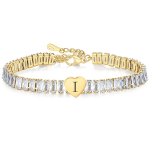 Detail of gold tennis bracelet with rectangular zircons and a heart pendant letter I