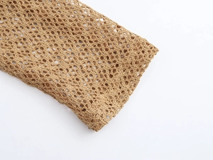 Close-up of khaki crochet mesh fabric showing hollow knit texture and beach style detail