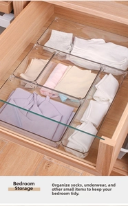 Close-up of clear PET drawer organizers for organizing socks and underwear in a wooden drawer