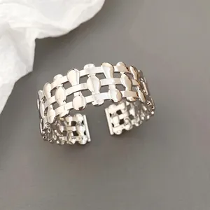 Modern silver hollow woven open ring with high-polished teardrop elements and adjustable band
