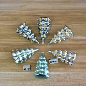 Detail of blue and silver Christmas tree ornaments with yellow dotted accents and hanging rings