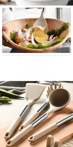 Detail of 10-piece cream silicone kitchen utensil set with stainless steel handles and bowl