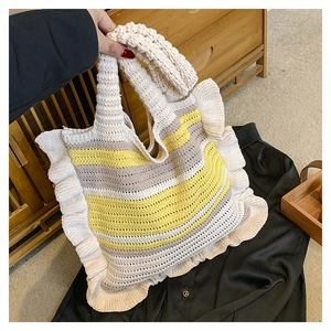 Detail showing the ruffle edge and striped knit texture of the handmade tote bag