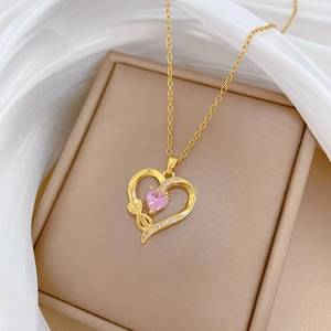 Elegant gold titanium heart necklace with pink gemstone and micro-pave crystals