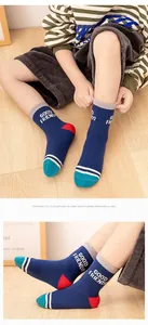 Detail of colorful cotton crew socks for kids with side letter print and knit texture
