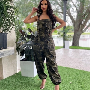 Detail of army green camouflage utility jumpsuit with large pockets in outdoor setting