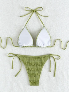 Detailed view of grass green ribbed bikini fabric with halter ties and textured finish