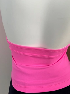 Detailed close-up of the bright pink knitted halter top showing fine fabric texture