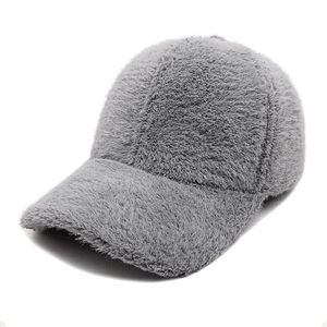 Close-up of soft grey faux fur texture on a classic curved brim baseball cap for winter