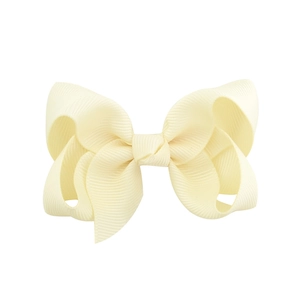 Close-up of a pale yellow grosgrain ribbon double bow hair clip on a white background