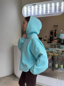 Oversized light blue hoodie for women with minimalist street style and drop shoulder fit