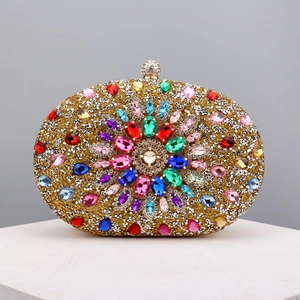 Close-up of golden evening clutch bag featuring colorful crystals and a metal clasp