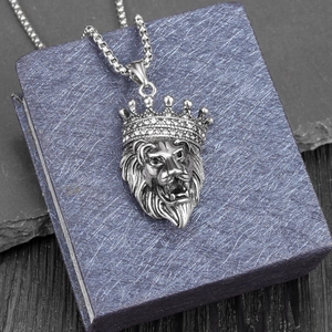 Detail of silver crown lion head pendant with diamonds on a premium textured gift box