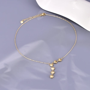 Detail of 18K gold-plated Y-shaped necklace featuring five cascading heart pendants