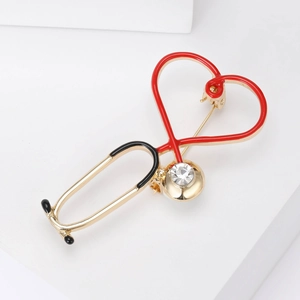 Macro detail of doctor stethoscope brooch with red enamel and sparkling rhinestones