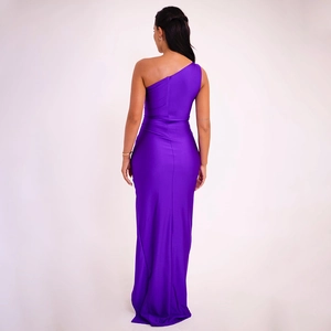 Rear view of a slim fit purple one shoulder long dress with a high slit and glossy fabric