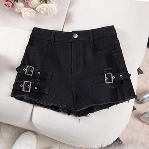 Detail of high waisted black denim shorts with metal buttons and distressed ripped accents