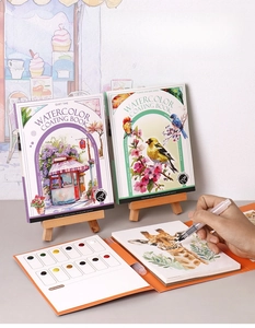 Detailed close-up of a portable watercolor coating book with built-in paint and a brush