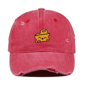 Detailed view of cheese embroidery and distressed edge on watermelon red baseball cap