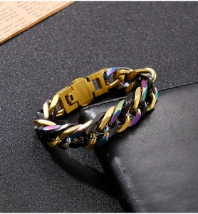 Detail of tricolor titanium steel Cuban bracelet with gold, black, and rainbow links