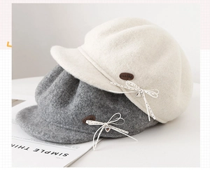 Detail of wool blend newsboy caps with polka dot bows and silver heart charms
