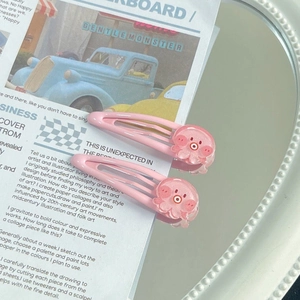 Pair of cute pink octopus snap hair clips with glitter details on a decorative card