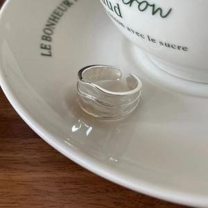 Close-up of S925 sterling silver irregular wavy wide ring with polished hammer texture