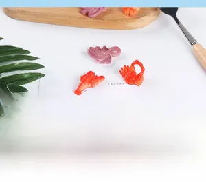 Flat lay of realistic PVC seafood models like lobster and crab for DIY decor