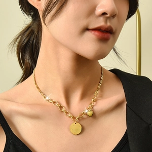 Gold layered chain necklace with heart pendant and engraved circular tag for women