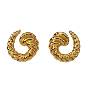 Elegant gold spiral horn earrings with minimalist twisted texture on white background