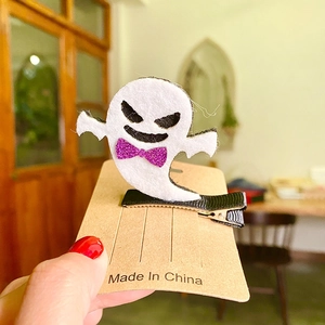 Halloween ghost hair clip with purple glitter bow on black ribbon lined alligator clip