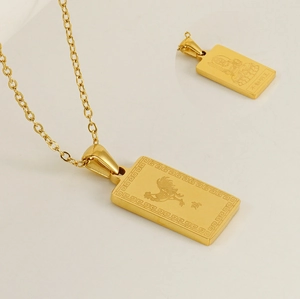Macro shot of 18K gold plated stainless steel rectangle pendant with zodiac engraving
