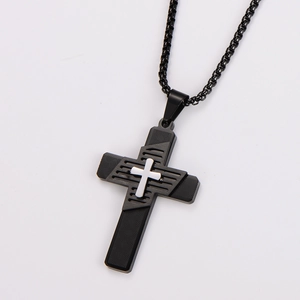 Close-up of black stainless steel double-layer cross pendant with geometric texture