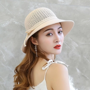 Foldable beige woven straw sun hat for women with elegant bow tie decoration