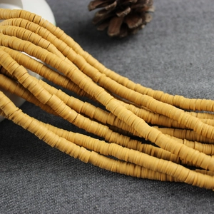 Close-up of 4mm yellow polymer clay spacer beads strands for DIY jewelry making