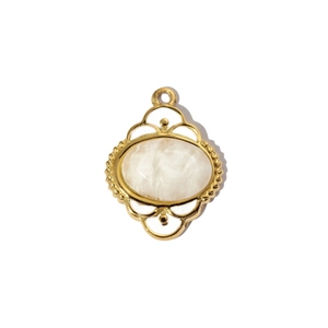 Detail of vintage gold tree of life pendant with white marble stone and hollow frame